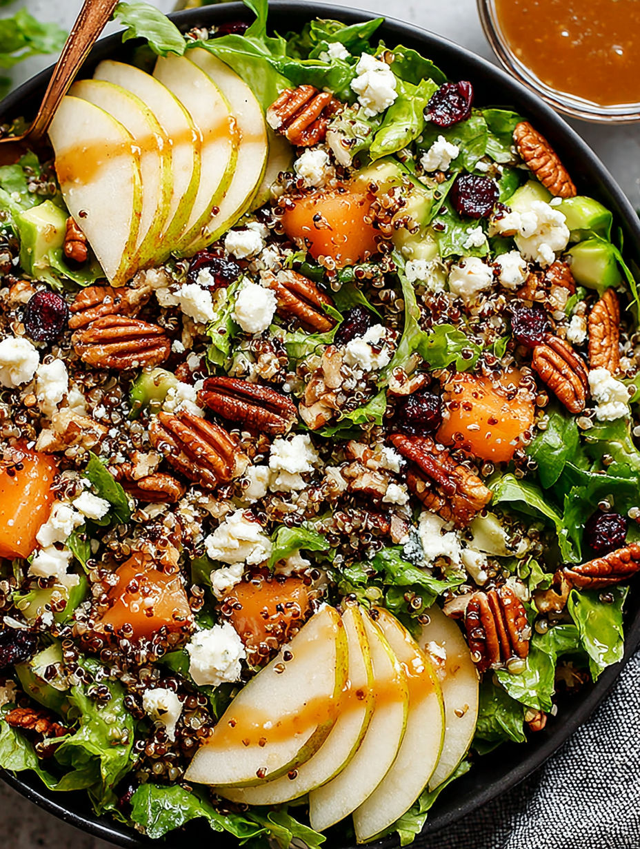 A salad with apples, nuts, and cheese.