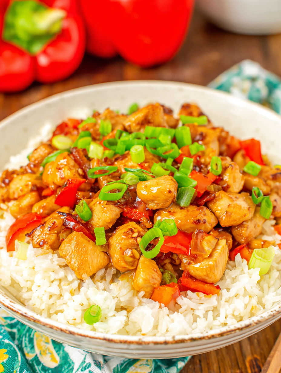 A bowl of rice and chicken with peppers.