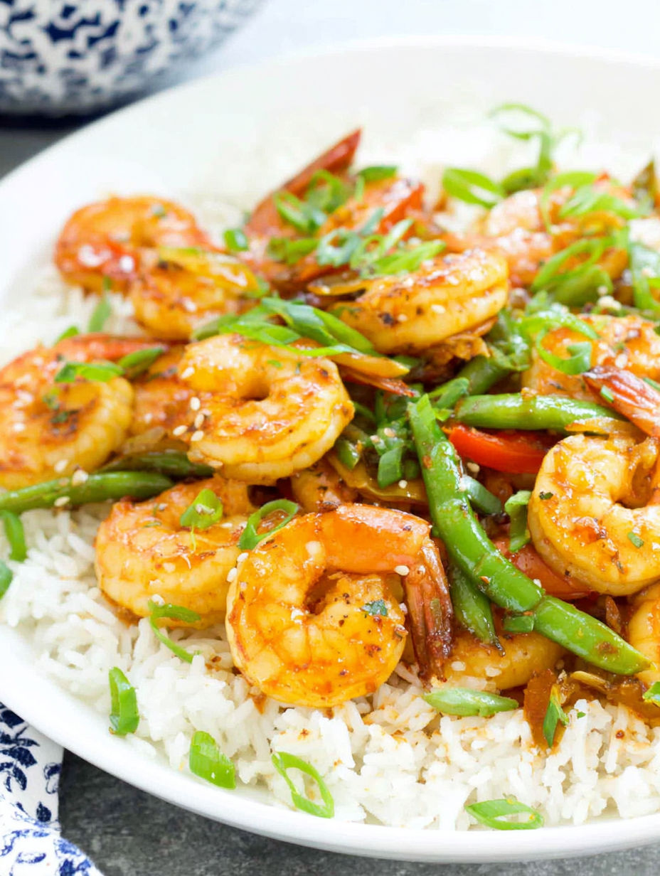 A plate of shrimp stir fry with rice.