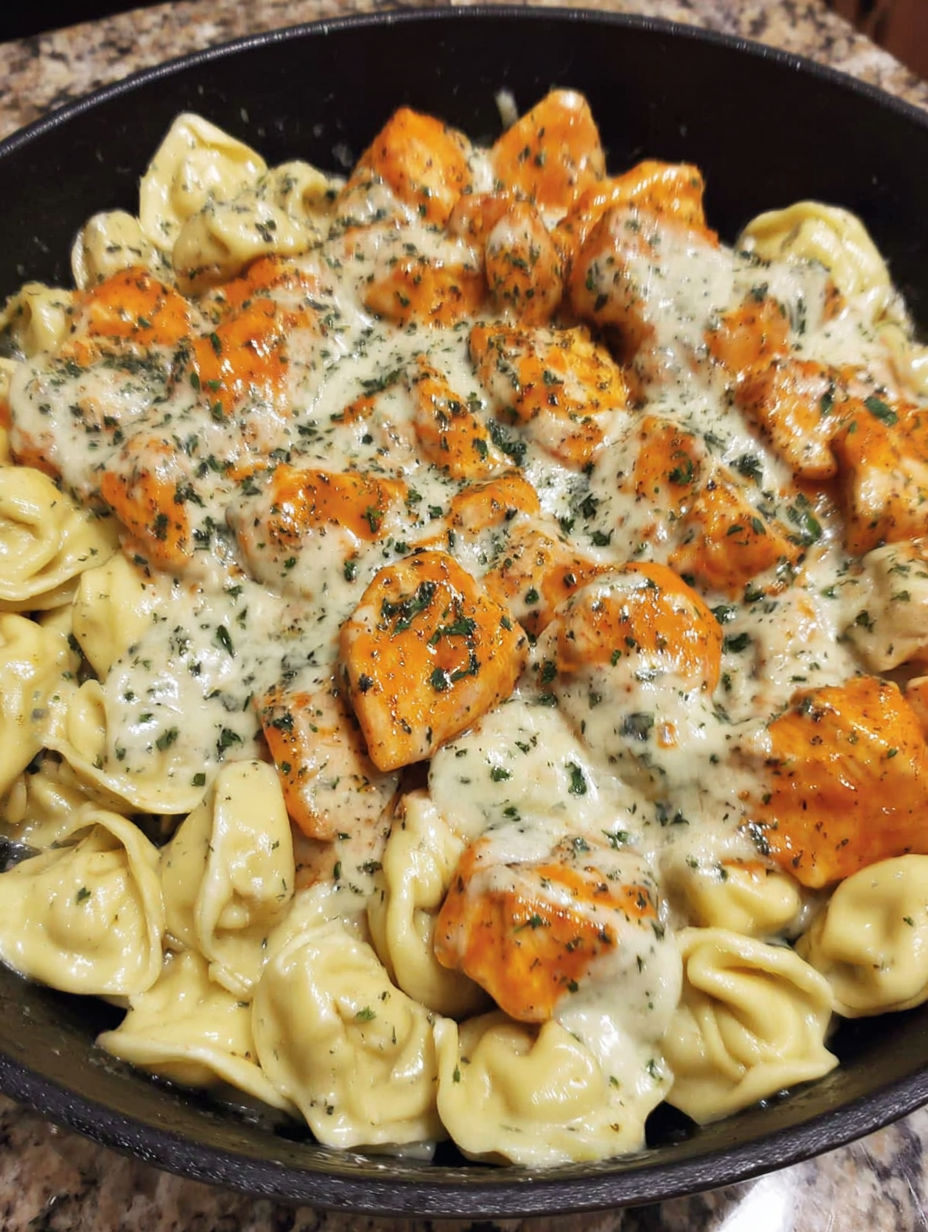 A dish of pasta with chicken and cheese.