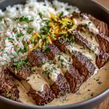 A bowl of food with rice, meat, and cheese.