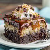A slice of German Chocolate Poke Cake.