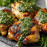 Grilled chicken thighs with basil chimichurri.