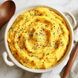 A bowl of creamy pumpkin mashed potatoes.