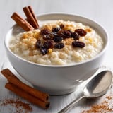 A bowl of rice pudding with cinnamon on top.