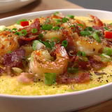 A white bowl filled with shrimp and grits.