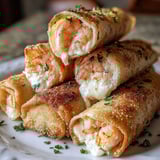 Creamy shrimp cheese rolls on a plate.