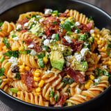 A bowl of Mexican street corn pasta salad.