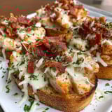 A plate of chicken alfredo garlic toast.