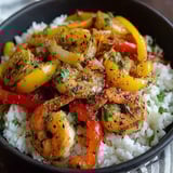 A bowl of shrimp and peppers.