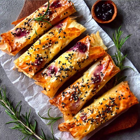A plate of cranberry and brie filo crackers.