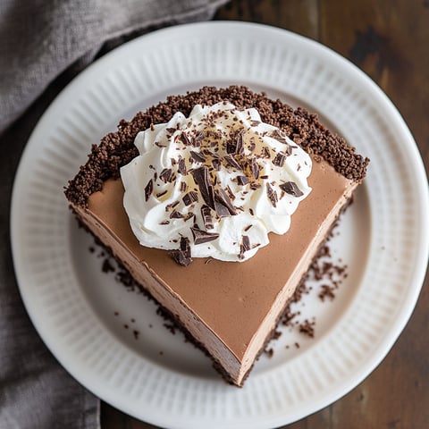 A slice of chocolate espresso cheesecake on a white plate.