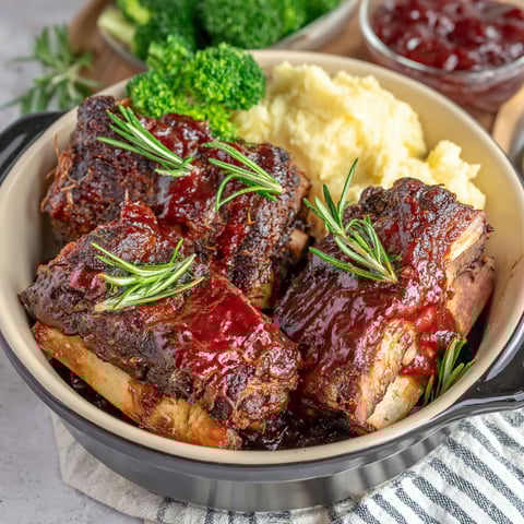 A crockpot filled with BBQ beef ribs.