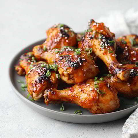 A plate of gluten-free maple sriracha chicken legs.